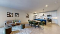 Located at 165 North St in Stamford, CT, this thoughtfully designed one-bedroom, two-bathroom residence offers a well-appointed single-floor layout with a clean, contemporary aesthetic. Light hardwood flooring flows throughout, tying together the open-concept living, dining, and kitchen areas. The kitchen is a standout feature, boasting a large dark-finished island with white quartz countertops, crisp white cabinetry, a subway tile backsplash, stainless steel appliances, and bold pendant lighting that anchors the space. The living and dining area is bright and airy, with large windows inviting generous natural light. The bedroom is a serene retreat, featuring floor-to-ceiling windows with outdoor views, soft neutral tones, and warm hardwood floors. A dedicated office provides a quiet, functional workspace complete with built-in shelving. The two bathrooms are finished to a high standard — one features large-format marble-style wall tiles surrounding a soaking tub, while the other offers a modern floating vanity with an LED-backlit mirror and tile flooring. A closet completes the layout, ensuring practical storage. The overall ambiance is modern, polished, and thoughtfully curated for comfortable urban living.
