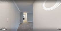 This contemporary apartment in Falls Church, VA, offers 890 square feet of thoughtfully designed living space. The property features two bedrooms, including a generous primary bedroom of 160 square feet, and one full bathroom. The open-concept living area seamlessly integrates with a modern kitchen, showcasing dark wood cabinetry, granite countertops, and stainless steel appliances. A breakfast bar provides additional seating and separates the kitchen from the carpeted living space.

Throughout the apartment, neutral gray walls and plush carpeting create a cohesive, inviting atmosphere. Large windows in the living room and bedrooms allow for ample natural light, while sliding glass doors in the main living area lead to a private balcony, extending the living space outdoors.

The bathroom has been updated with a granite-topped vanity, modern lighting, and a large mirror. Built-in closets in the bedrooms offer practical storage solutions. Recessed lighting and modern ceiling fixtures provide well-distributed illumination throughout the space.

The apartment's layout maximizes functionality and comfort, making efficient use of the available square footage. Its location at 2148 Iroquois Ln in Falls Church adds to its appeal, offering suburban tranquility with urban convenience.