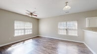 This well-appointed 2-bedroom, 2-bathroom residence in Horn Lake, Mississippi, offers a thoughtfully designed single-floor layout with a range of practical features. The bright and open living room is finished with durable wood-look flooring and features a ceiling fan, pendant lighting, and multiple windows fitted with blinds that invite generous natural light throughout the day. The kitchen is equipped with white cabinetry, ample counter space, a black electric range with an over-the-range microwave, and an adjacent pantry for additional storage. A hallway connects the main living areas to the private sleeping quarters. Both bedrooms are carpeted for comfort, with the primary bedroom offering a spacious walk-in closet outfitted with wire shelving systems and direct access to a private balcony. The second bedroom also features plush carpeting and a well-sized closet. Both bathrooms include tub-shower combinations with clean white surrounds and vanities with white cabinetry. Wood-look flooring extends through the bathrooms for a cohesive aesthetic. Additional conveniences include a dedicated laundry area and utility rooms, rounding out a practical and comfortable living space.
