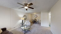 Located at 1000 S Clack St in Abilene, Texas, this single-floor, 3-bedroom, 1-bathroom home offers a practical and comfortable layout. The combined living and dining area serves as the heart of the home, featuring soft carpeting, neutral walls, and a ceiling fan with integrated lighting. A pass-through kitchen counter connects the kitchen to the dining space, creating an open, communicative feel. The kitchen is equipped with essential appliances, including a range and refrigerator, with ample cabinetry above and below the counters. The three bedrooms are each carpeted and fitted with ceiling fans, providing comfort throughout. The primary bedroom is notably spacious and includes a walk-in closet, while the additional bedrooms feature standard closets. Natural light filters in through blinds-covered windows in each bedroom. The single full bathroom is clean and bright, offering a tub-shower combination, a vanity with storage, and light wood-style flooring. A hallway connects the bedrooms and bathroom, adding to the home's efficient flow. Textured ceilings are consistent throughout the space, lending a classic residential character to this well-organized Abilene home.