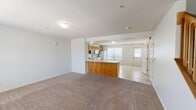 Located at 5801 Copper Beech Blvd in Kalamazoo, Michigan, this two-story home offers 2 bedrooms and 3 bathrooms spread across two well-proportioned floors. The main level features an open-concept layout where the living room flows seamlessly into the kitchen, which is equipped with warm oak cabinetry, a peninsula with counter seating, and white appliances. Light tile flooring anchors the kitchen and entry areas, while plush carpet covers the living room, creating a comfortable and inviting atmosphere. Large windows on the main floor allow natural light to pour in and offer pleasant outdoor views of the surrounding greenery. A wood-railed staircase with clean white walls connects the two floors. The upper level houses both bedrooms, each finished with soft carpet and multiple windows that frame natural light beautifully. The spacious primary bedroom is notably generous in size. Three bathrooms serve the home, including full baths featuring tiled floors, a tub-shower combination, and wood-toned vanities. A convenient half bath is also present on the main level. Throughout the home, neutral tones, textured ceilings, and consistent finishes create a clean, functional aesthetic well-suited for comfortable everyday living.