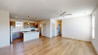 Located at 22220 Barbour Way in Charlotte, NC, this 2-bedroom, 3-bathroom residence offers a thoughtfully designed single-floor layout with a blend of modern finishes and functional living spaces. The open-concept living room features warm hardwood-style flooring, multiple windows that invite abundant natural light, a ceiling fan, and a sliding glass door that connects the interior to the outdoors. The well-appointed kitchen is a standout, featuring rich dark wood cabinetry, stainless steel appliances, a subway tile backsplash, a granite-topped center island with pendant lighting overhead, and a seamless flow into the living and dining areas. Each bedroom is carpeted for comfort and equipped with a ceiling fan. The generously sized primary bedroom includes a walk-in closet outfitted with wire shelving systems for organized storage. The bathrooms are clean and bright, with one featuring a soaking tub and tiled surround, and another showcasing wood-look flooring, a granite-topped vanity, and a natural light-filled window. A dedicated laundry room with in-unit washer hookups adds everyday convenience. The overall ambiance is light, neutral, and move-in ready.