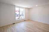 Located at 2620 W Girard Ave in Philadelphia's vibrant Fairmount neighborhood, this modern 1-bedroom, 2-bathroom multi-level home is thoughtfully designed across three floors. Light-toned hardwood flooring runs throughout, complementing the clean white walls and recessed lighting that give the space a bright, contemporary feel.

The main floor hosts a spacious living room with recessed lighting and an open, airy atmosphere. The well-appointed kitchen features a two-tone cabinet design — dark lower cabinets paired with white uppers — accented by a distinctive blue subway tile backsplash, light quartz countertops, stainless steel appliances including a range, microwave, dishwasher, and refrigerator, and matte black hardware throughout.

Both bathrooms carry the cohesive design language with white and blue tile detailing, gray vanities with undermount sinks, and matte black fixtures. One bathroom offers a tub-shower combo, while the other features a glass-enclosed walk-in shower.

The bedroom is a comfortable, well-proportioned retreat featuring a sliding double-door closet, natural light from large windows, and views of the surrounding Philadelphia streetscape. Additional floors provide flexible living or utility space, connected by staircases that make the vertical layout practical and accessible.