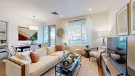 Located in Phoenix, AZ, this single-story, 2-bedroom, 2-bathroom residence offers a clean, modern aesthetic with an efficient and well-organized layout. The open-concept living area is bright and welcoming, with large windows that flood the space with natural light and offer outdoor views. Wood-style flooring runs through the main living areas, adding warmth to the contemporary design.

The kitchen is a functional centerpiece, featuring gray cabinetry, granite countertops, stainless steel appliances, and a large island with bar seating and pendant lighting overhead — ideal for both cooking and casual dining. A dedicated pantry closet and entry hooks provide practical everyday storage.

Both bedrooms are comfortably sized, each equipped with a ceiling fan and access to a closet. The primary bedroom includes a walk-in closet and an en-suite bathroom with a double-sink vanity, granite counters, wood-look flooring, and a glass-enclosed shower. The second bathroom features a tub-shower combination with clean white tile and a granite-topped vanity.

Three closets throughout the unit ensure ample storage, while an in-unit laundry area adds convenience. The overall design is cohesive and modern, with a neutral palette that lends itself to a calm, livable atmosphere.
