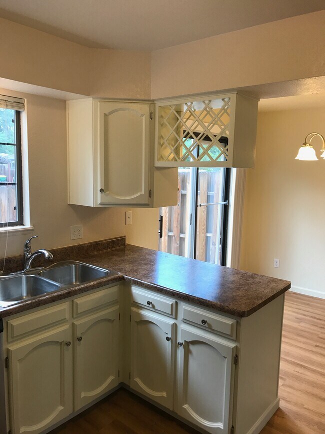Kitchen with attached eating area and sliding door access to large fenced backyard and patio - 5205 Cody St