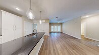 Located at 4434 Cobalt Brook Boulevard in Lutz, Florida, this single-story, 3-bedroom, 2-bathroom home offers a well-designed layout with modern finishes throughout. Wood-look flooring runs consistently across the entire home, creating a cohesive and clean aesthetic.

The open-concept kitchen and living area serves as the heart of the home. The kitchen features white shaker-style cabinetry, dark granite countertops, a subway tile backsplash, stainless steel appliances including a French door refrigerator and range, and elegant pendant lighting over the island. The adjoining living area is bright and spacious, with access to the outdoors through French doors and a ceiling fan overhead.

The three bedrooms are well-proportioned, each outfitted with ceiling fans and natural light from windows with blinds. The primary bedroom is generously sized and benefits from a walk-in closet with wire shelving systems. A total of four closets provide ample storage throughout the home.

Both bathrooms are finished with white cabinetry, dark granite countertops, undermount sinks, chrome fixtures, and tub-shower combinations with tile surrounds. The hallway connects all rooms efficiently, maintaining a practical and comfortable flow throughout the single-floor layout.