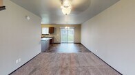 Located at 3131 S Broek Dr in Sioux Falls, South Dakota, this two-story home offers a practical and comfortable layout spread across two well-designed floors. The main level features an open-concept living and dining area, where durable wood-look flooring transitions seamlessly into plush carpeting in the living space. A sliding glass door brings in natural light and provides outdoor access, while a ceiling fan with light fixture adds to the room's functionality. The kitchen is equipped with dark or medium-toned cabinetry, light-colored countertops, and black Whirlpool appliances including an electric range and over-the-range microwave, complemented by a peninsula that connects the kitchen to the living area. A staircase leads to the upper level, where carpeted bedrooms offer a quiet retreat. Each bedroom features windows that allow for natural light and views of the surrounding neighborhood. The bathrooms throughout the home include rich tile flooring in earthy tones, dark wood vanities, and chrome fixtures. Safety grab bars are present in select bathrooms, and the full bath includes a tub/shower combination. The neutral color palette and consistent finishes throughout create a cohesive and move-in-ready living environment.