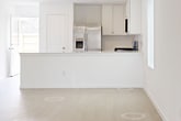 This contemporary single-story home in New Caney, TX offers 1300 square feet of well-designed living space. The property features three bedrooms, including a generous 200 square foot primary bedroom, and two full bathrooms. The heart of the home is an open-concept living area, seamlessly connecting the kitchen and living room. The kitchen boasts modern white cabinetry, stainless steel appliances, and a gas range, creating an ideal space for cooking and entertaining. Throughout the home, you'll find a mix of flooring, with plush carpeting in the bedrooms and sleek hard surface flooring in the main living areas. The bathrooms are designed with functionality in mind, featuring a spacious walk-in shower with built-in shelving. Large windows in the bedrooms and living areas allow for ample natural light, while ceiling fans provide additional comfort. The property includes an attached garage and a fenced backyard, perfect for outdoor activities. With its practical layout and contemporary finishes, this home offers a comfortable and stylish living environment.