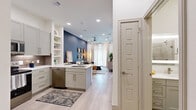 Located at 2014 Southside Blvd in Allen, TX, this thoughtfully designed one-bedroom, one-bathroom residence offers a cohesive open-concept floor plan that maximizes every square foot. Light wood-tone flooring flows throughout, creating a seamless transition between spaces. The kitchen is a functional centerpiece, equipped with stainless steel GE appliances — including a French door refrigerator, range, microwave, and dishwasher — complemented by gray shaker-style cabinetry, a geometric tile backsplash, white quartz countertops, and an island with an undermount sink and bar seating. Open shelving adds both storage and display space. The living room makes a bold statement with a deep navy accent wall, ceiling fan, and large windows dressed in sheer curtains that invite abundant natural light. The bedroom features a vibrant teal accent wall, large windows with plantation shutters and rich rust-colored drapes, and a dedicated closet. The bathroom is finished with gray cabinetry, a white quartz vanity, a glass-enclosed shower, and clean, modern fixtures. Recessed lighting throughout enhances the bright, contemporary ambiance of this well-appointed residence.