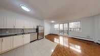 Located at 28 Helene St N in Mississauga, this one-bedroom, one-bathroom unit offers a well-utilized layout across a single floor. The open-concept kitchen and living area creates a seamless flow, with the kitchen showcasing white shaker-style cabinetry, dark countertops, a subway tile backsplash, and a full suite of stainless steel appliances including a range, over-the-range microwave, refrigerator, and dishwasher. Light tile flooring in the kitchen transitions into warm, richly toned parquet wood flooring that extends throughout the living and sleeping areas, adding character to the space.

The living area is bright and airy, benefiting from large sliding glass doors that open onto a private balcony, offering open views of the surrounding Mississauga cityscape and neighbouring residential towers. Natural light flows generously through multiple windows equipped with baseboard heating beneath them.

The bedroom is a comfortable, well-proportioned room featuring the same parquet flooring, a large window with city views, and a built-in sliding door closet. The bathroom is finished with large-format neutral tiles surrounding a soaker tub with a handheld shower, conveying a clean and modern aesthetic throughout.