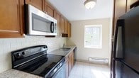 Located at 300 S Central Ave in Hartsdale, NY, this single-floor one-bedroom, one-bathroom residence offers a clean and functional layout designed for comfortable everyday living. The kitchen is a standout feature, showcasing warm honey-toned wood cabinetry that provides ample storage, complemented by granite countertops and a classic white subway tile backsplash. Stainless steel appliances — including an electric range, over-the-range microwave, and dishwasher — lend a modern, polished feel to the space. Light-toned tile flooring runs throughout the kitchen, keeping the area bright and easy to maintain. A single window allows natural light to filter into the kitchen, enhancing its open and airy atmosphere. A baseboard heating unit ensures year-round comfort. The neutral wall tones throughout create a versatile backdrop, making the space easy to personalize. The overall ambiance is tidy, well-maintained, and move-in ready, offering a practical yet inviting environment in the heart of Hartsdale, a hamlet within the Town of Greenburgh in Westchester County, New York.