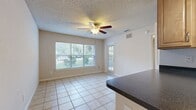 This 450 square foot apartment in Altamonte Springs, FL, offers a well-designed living space on a single floor. The layout includes one bedroom, measuring 130 square feet, and two bathrooms, providing convenience and privacy. The kitchen is a highlight, featuring light wood cabinetry, stainless steel appliances, and a tiled floor. It's equipped with a refrigerator, microwave, oven, and dishwasher, making it fully functional for daily cooking needs. The living areas are carpeted in a neutral tone, creating a cozy atmosphere. The bedroom includes a ceiling fan for comfort and has direct access to a closet. Storage is maximized with built-in shelving in the closet areas. The bathrooms are practical, with one featuring a bathtub-shower combination. Throughout the apartment, the color scheme is neutral, allowing for personalization. The layout appears to include a small dining or work area adjacent to the kitchen. Despite its compact size, the apartment feels open and bright, with a thoughtful design that makes efficient use of the available space.
