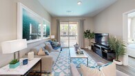 Located at 9860 W Tropicana Ave in Las Vegas, NV, this well-appointed one-bedroom, one-bathroom residence offers a thoughtfully designed layout across a single floor. The open-concept kitchen and living area serves as the heart of the home, where the kitchen impresses with stainless steel appliances — including a gas range, microwave, and refrigerator — two-tone cabinetry in light and dark finishes, white countertops, and a peninsula with bar seating illuminated by pendant lighting. A built-in wine rack adds a distinctive touch above the refrigerator. The living room is bright and inviting, with wood-style flooring, recessed lighting, and a sliding glass door that opens to a private balcony overlooking the surrounding community. The bedroom features plush carpeting, a ceiling fan, and large windows that welcome natural light and outdoor views of palm trees. It connects directly to a dedicated walk-in closet, offering generous storage. The full bathroom is clean and modern, with wood-look tile flooring, a dark-finished vanity with an illuminated mirror, and a full tub-shower combination. Throughout the space, neutral tones and contemporary finishes create a cohesive, comfortable atmosphere.