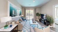 Located at 9860 W Tropicana Ave in Las Vegas, NV, this well-appointed one-bedroom, one-bathroom residence offers a thoughtfully designed layout across a single floor. The open-concept kitchen and living area serves as the heart of the home, where the kitchen impresses with stainless steel appliances — including a gas range, microwave, and refrigerator — two-tone cabinetry in light and dark finishes, white countertops, and a peninsula with bar seating illuminated by pendant lighting. A built-in wine rack adds a distinctive touch above the refrigerator. The living room is bright and inviting, with wood-style flooring, recessed lighting, and a sliding glass door that opens to a private balcony overlooking the surrounding community. The bedroom features plush carpeting, a ceiling fan, and large windows that welcome natural light and outdoor views of palm trees. It connects directly to a dedicated walk-in closet, offering generous storage. The full bathroom is clean and modern, with wood-look tile flooring, a dark-finished vanity with an illuminated mirror, and a full tub-shower combination. Throughout the space, neutral tones and contemporary finishes create a cohesive, comfortable atmosphere.