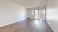 This contemporary 750 square foot apartment in Anaheim, CA offers a well-designed living space with two bedrooms and two bathrooms. The open floor plan creates a seamless flow between the living areas, enhancing the sense of spaciousness. The kitchen has been updated with white cabinetry, marble-look countertops, and stainless steel appliances, providing a sleek and functional cooking space.

The primary bedroom, measuring 150 square feet, offers ample room for a comfortable retreat. Both bedrooms feature large windows that allow natural light to flood the spaces, and are equipped with mirrored closet doors to maximize storage and create an illusion of more space.

The bathrooms are modern and pristine, with one featuring a shower-tub combination and the other a walk-in shower. Both have been outfitted with white vanities and chrome fixtures.

Throughout the apartment, wood-look vinyl flooring adds warmth and durability. The neutral color palette of whites and greys creates a clean, fresh ambiance that allows for personalization. Large windows in the living area and bedrooms provide views of the surroundings and fill the space with natural light.

This single-story apartment combines comfort and style, making it an ideal home for those seeking a contemporary living space in Anaheim.