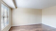Located at 4663 Crystal Ball Dr. in Hilliard, Ohio, this multi-level home offers 2 bedrooms, 3 bathrooms, and a well-organized layout spread across three floors. Textured ceilings and warm, neutral tones run throughout, creating a cohesive and inviting atmosphere. The main living level features a bright living room with durable hardwood-style flooring and a window that brings in natural light. The combined dining room and kitchen is equipped with rich wood cabinetry, light countertops, and white appliances including a range, dishwasher, and refrigerator. The bathrooms feature wood-tone vanities, light countertops, framed mirrors, and hardwood-style flooring, with at least one including a full soaking tub. The two bedrooms are carpeted for comfort; the primary bedroom offers a generous footprint with a window overlooking the exterior, while the second bedroom includes a built-in closet with paneled doors. With seven closets spread across the home, storage is abundant throughout. A dedicated laundry area and two basement spaces add to the home's functionality. Stairways connect the three floors seamlessly, making the layout practical for everyday living.