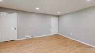 Located at 409 Easton Rd in Willow Grove, PA, this 2-bedroom, 1-bathroom unit offers a well-organized single-floor layout with a clean, updated aesthetic throughout. The living room features light hardwood-style flooring, recessed lighting, and a sliding glass door that opens to a private balcony overlooking lush, mature trees — bringing natural light and greenery into the space.

The kitchen is outfitted with crisp white shaker cabinets, light quartz countertops, black hardware accents, and stainless steel appliances including a range with over-the-range microwave and a full-size refrigerator, making it both functional and visually appealing.

The bathroom stands out with its elegant marble-look tile covering both the floors and the tub surround, complemented by a dark-toned vanity and sleek black fixtures, giving it a modern, upscale feel.

Both bedrooms are carpeted and finished in a neutral gray palette, providing a calm and comfortable atmosphere. The primary bedroom includes a closet with bifold doors, while each bedroom benefits from windows that allow natural light to filter in. Baseboard heating and wall AC units are present throughout, ensuring year-round comfort. The unit offers a practical and well-appointed living experience in a convenient suburban location.