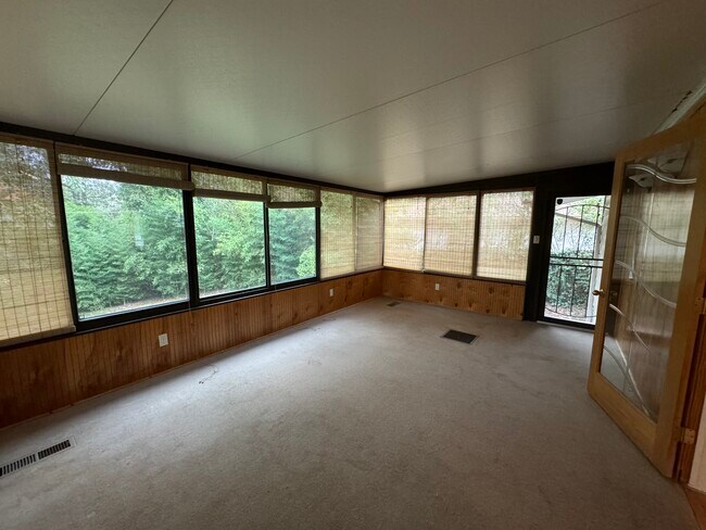 Large sunroom with windows on 3 sides. - 3708 Idlewild Ave