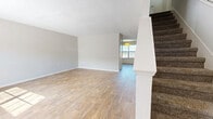 Located at 1614 Zermatt Ave in Nashville, TN, this two-story home offers three bedrooms and three bathrooms across a well-organized layout. The main floor features an open living area with light wood-style flooring, neutral gray walls, and a textured ceiling, all bathed in natural light from forward-facing windows. A carpeted staircase leads to the upper level. The kitchen is equipped with white cabinetry, a tile backsplash, and white appliances including a range, refrigerator, and dishwasher, with convenient access to an exterior door. The upper floor is slightly larger than the main level and hosts all three bedrooms, each finished with plush carpet and individual closets featuring wire shelving. The spacious primary bedroom includes its own dedicated closet. The three bathrooms vary in configuration — one features a tub/shower combo with a wood-toned vanity, while others offer simpler fixtures with clean white finishes and wood-style flooring. Throughout the home, a consistent neutral color palette and functional design create a clean, move-in-ready atmosphere well-suited for comfortable everyday living in the heart of Nashville.