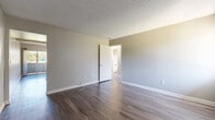 Located at 110 E Baseline Rd in San Dimas, CA, this single-floor unit offers three bedrooms and two bathrooms with a practical, well-organized layout. The galley-style kitchen is equipped with stainless steel appliances — including a gas range and dishwasher — white cabinetry, granite-look countertops, and a skylight that fills the space with natural light. A peninsula counter connects the kitchen to the main living area, which features wood-style laminate flooring and neutral gray walls throughout. The primary bedroom is a well-proportioned space with wood-style flooring and direct access to a bathroom. The secondary bedrooms feature plush carpeting and ample closet space, including sliding mirrored closet doors and traditional hinged double-door closets. The two bathrooms are finished with wood-style flooring, white vanity cabinetry with granite-look countertops, and a tub-shower combination. A hallway connects the main living areas to the bedrooms, providing a clear and functional flow throughout the unit. Clean, neutral finishes and consistent design choices create a cohesive and move-in-ready atmosphere throughout the home.