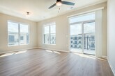 Located at 2692 Botanical Dr in Fitchburg, WI, this two-bedroom, two-bathroom single-floor residence offers a well-designed layout with a clean, modern aesthetic throughout. Light wood-tone flooring runs continuously across the space, complementing the neutral warm-beige walls and crisp white trim that define every room.

The open-concept kitchen and living area serves as the heart of the home, featuring white shaker-style cabinetry, a light quartz countertop island with seating, a subtle tile backsplash, stainless steel appliances, and pendant lighting that adds a refined touch. Large windows flood the living area with natural light.

A central hallway lined with recessed lighting and a double-door closet connects the bedrooms and bathrooms. The primary bedroom is generously proportioned, with multiple windows framing views of the surrounding community. The second bedroom also benefits from natural light and includes access to a walk-in closet with built-in shelving. Both bedrooms are served by well-appointed bathrooms — one featuring a single-sink vanity with white cabinetry and quartz countertop, and the other a walk-in shower with built-in shelving. Additional amenities include an in-unit laundry and a private patio.