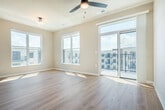 Located at 2692 Botanical Dr in Fitchburg, WI, this two-bedroom, two-bathroom single-floor residence offers a well-designed layout with a clean, modern aesthetic throughout. Light wood-tone flooring runs continuously across the space, complementing the neutral warm-beige walls and crisp white trim that define every room.

The open-concept kitchen and living area serves as the heart of the home, featuring white shaker-style cabinetry, a light quartz countertop island with seating, a subtle tile backsplash, stainless steel appliances, and pendant lighting that adds a refined touch. Large windows flood the living area with natural light.

A central hallway lined with recessed lighting and a double-door closet connects the bedrooms and bathrooms. The primary bedroom is generously proportioned, with multiple windows framing views of the surrounding community. The second bedroom also benefits from natural light and includes access to a walk-in closet with built-in shelving. Both bedrooms are served by well-appointed bathrooms — one featuring a single-sink vanity with white cabinetry and quartz countertop, and the other a walk-in shower with built-in shelving. Additional amenities include an in-unit laundry and a private patio.