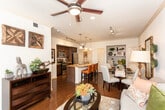 Located at 2741 Faudree Rd in Odessa, Texas, this single-floor residence offers a thoughtfully designed open-concept layout that seamlessly connects the kitchen, dining, and living areas. Rich hardwood flooring flows throughout the main living spaces, anchoring the warm and inviting atmosphere.

The kitchen is a standout feature, equipped with stainless steel appliances, dark espresso cabinetry, and a granite-topped island with a built-in sink and bar seating for multiple guests. Pendant lighting and track lighting illuminate the space with both style and practicality.

The living room is bright and welcoming, benefiting from large windows dressed with sheer curtains and blinds that allow generous natural light while maintaining privacy. A direct-access exterior door adds convenience to the living area.

The bedroom is a comfortable retreat, featuring plush carpeting, a ceiling fan, and windows that bring in soft natural light. Ample space accommodates a full suite of furnishings with ease.

The bathroom continues the granite countertop theme, paired with a large vanity mirror, dark cabinetry, and a tub-shower combination with tiled surrounds. Throughout the residence, crown molding and consistent finishes contribute to a cohesive, polished aesthetic.