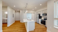 This contemporary 890 square foot apartment in Omaha, NE offers a harmonious blend of style and functionality. The open-concept design seamlessly integrates the kitchen and living areas, creating a spacious feel. The kitchen is a highlight, featuring pristine white cabinetry, stainless steel appliances, and a convenient island with a sink, perfect for meal preparation and casual dining.

The apartment boasts two bedrooms, including a primary bedroom of 160 square feet, providing ample space for relaxation. The single bathroom is well-appointed with modern fixtures, a combination tub-shower, and a vanity with storage.

Throughout the apartment, hardwood floors in warm tones contrast beautifully with the neutral wall colors, creating a bright and inviting atmosphere. Large windows with blinds allow for abundant natural light and privacy control. Recessed lighting and ceiling fans add both functionality and style to the space.

The apartment's thoughtful design includes a closet for storage and convenient features like a sliding barn door, adding a touch of rustic charm to the contemporary aesthetic. With its blend of modern amenities and thoughtful design, this apartment offers comfortable and stylish living in the heart of Omaha.
