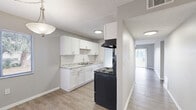 Located in Tampa, FL, this single-floor, 2-bedroom, 2-bathroom unit offers a functional and well-appointed layout across a comfortable footprint. The living room is bright and open, featuring light wood-style flooring and a sliding glass door with vertical blinds that opens onto a private patio, allowing natural light to flow in while providing pleasant outdoor views. The galley-style kitchen is efficiently designed with white shaker cabinetry on both sides, granite-look countertops, a tiled backsplash, a stainless steel sink, and black appliances including a range and refrigerator. The layout connects the kitchen directly to the living area, supporting an easy flow throughout the unit. Both bedrooms are comfortably sized with neutral gray walls and wood-style flooring. The primary bedroom includes a large sliding double closet, while the second bedroom features a window that brings in natural light. Each bedroom is served by its own bathroom. One bathroom includes a full tub-shower combination with white tile surround and a white vanity, while the second bathroom features a standalone shower and matching white finishes. Hallways connect the rooms efficiently, and two dedicated closets provide additional storage. The textured ceilings and clean, neutral palette throughout give the space a cohesive and move-in-ready appearance.