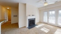 Located at 205 Reserve Blvd in Charlottesville, Virginia, this single-floor residence offers a well-organized layout with a cohesive, neutral aesthetic throughout. The kitchen is a functional highlight, outfitted with rich warm-toned wood cabinetry, granite countertops, tile flooring, and a full suite of stainless steel appliances including a refrigerator, electric range, microwave, and dishwasher. Track lighting above adds practical illumination. The kitchen opens toward the living area, which centers around a classic fireplace with a white mantel and dark slate surround. Ceiling fans are present throughout the living and bedroom spaces, contributing to comfort and air circulation. Natural light filters through blinds-equipped windows across multiple rooms. The bedrooms feature plush carpeting, ceiling fans, and closets, creating comfortable, well-lit retreats. Two full bathrooms mirror each other in design, each offering a vanity with wood cabinetry, a white countertop with sink, tub-shower combination, and warm-toned tile flooring. Overall, the space presents a clean, functional, and move-in-ready environment suited for everyday living in the Charlottesville area.
