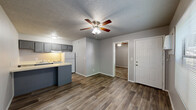 This compact 370 square foot apartment in Sand Springs, Oklahoma, offers a practical living solution in a single-story layout. The space comprises one bedroom, one bathroom, a kitchen, and a closet, efficiently designed to maximize functionality.

The 110 square foot primary bedroom features neutral-toned carpet and walls, with a ceiling fan for comfort. A window allows natural light, and the room connects directly to the main living area. The bathroom, while compact, includes essential fixtures with a combined tub and shower unit, toilet, and simple finishes.

The kitchen is a highlight of the apartment, showcasing recent updates. It features gray cabinetry, providing ample storage, and is equipped with a full-size refrigerator, oven, and dishwasher. Under-cabinet lighting enhances the workspace, and a peninsula extends into the living area, offering additional counter space and potential for casual dining.

The main living area boasts wood-look flooring, creating a modern and easy-to-maintain surface. The neutral color palette throughout the apartment allows for versatile decorating options. While the space is compact, the layout is thoughtfully designed to create distinct areas for sleeping, living, and dining.

This apartment is ideal for singles or couples seeking an efficient, low-maintenance living space in a convenient Oklahoma location.