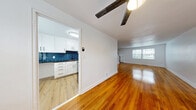 Located at 283 Cooper Pl in New Haven, CT, this three-bedroom, one-bathroom home is spread across three floors, offering a well-organized and functional layout. Polished hardwood floors run throughout the main and upper levels, lending warmth and continuity to every room.

The main floor features an open living area filled with natural light from large windows, complemented by a ceiling fan. It flows directly into a renovated kitchen equipped with white shaker cabinets, dark granite countertops, a striking blue subway tile backsplash, and a back door that provides convenient exterior access.

The full bathroom continues the blue tile motif, featuring a full tub-shower combination with bold blue subway tile surround, wood-look floor tile, and a white vanity with black hardware accents.

The three bedrooms are bright and well-proportioned, each featuring hardwood floors, neutral white walls, and windows that bring in natural light. The spacious primary bedroom offers a generous footprint. Five closets are distributed throughout the home, ensuring ample storage.

The basement provides additional utility space, housing the mechanical systems including the furnace, HVAC ductwork, and washer/dryer hookups, with room for extra storage. Staircases connect all three levels, completing this well-appointed New Haven home.