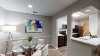 Located at 3500 Beaver Place Rd in Lexington, Kentucky, this single-floor residence offers a well-designed layout that balances comfort and functionality. The living room serves as a welcoming central space, featuring plush carpeting, a ceiling fan, and a sliding glass door that opens to an outdoor patio, allowing natural light to pour in and providing a pleasant outdoor view.

The galley-style kitchen is thoughtfully appointed with dark espresso lower cabinetry, crisp white upper cabinets, light quartz countertops, a classic white subway tile backsplash, and stainless steel appliances including an electric range and built-in microwave. Wood-look flooring runs throughout the kitchen and connects seamlessly to an adjacent dining area, which features a glass-top table and a vibrant abstract wall accent.

The residence includes two bedrooms, each finished with soft carpet, neutral gray walls, and windows that bring in natural light. Both rooms offer a calm, restful atmosphere with ample space. Two full bathrooms serve the home — one featuring a tub/shower combination and the other a walk-in shower — both finished with wood-look flooring, warm wood vanities, and clean white fixtures. The overall aesthetic throughout is contemporary and cohesive, with neutral tones creating a move-in ready environment.