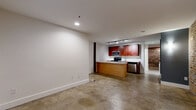 Located at 219 E Bank St in Petersburg, VA, this one-bedroom, one-bathroom unit offers an efficient and thoughtfully designed single-floor layout that balances industrial charm with contemporary updates. The open-concept living area seamlessly connects the living room, dining space, and kitchen, all unified by polished concrete floors that run throughout the unit. A central kitchen island anchors the space, complemented by rich cherry wood cabinetry, white countertops, stainless steel appliances — including a range, built-in microwave, and dishwasher — and track lighting overhead. Exposed brick walls add a striking architectural detail, lending warmth and historic character to the modern interior. The bedroom is a comfortable size, featuring a window that brings in natural light, access to a closet, and a dedicated electrical panel. The full bathroom includes a soaking tub with shower surround. A dedicated laundry area with side-by-side washer and dryer connections provides added convenience. Two closets offer practical storage throughout the unit. The overall ambiance is urban and character-rich, making it an ideal space for those who appreciate the aesthetic of historic architecture paired with updated, functional living.