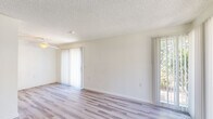 Located at 35 W Clover St in Woodland, CA, this one-bedroom, one-bathroom unit offers a practical and comfortable single-floor layout. The open living and dining area is bright and welcoming, featuring light hardwood-style flooring, a textured ceiling, and multiple large windows with vertical blinds that allow abundant natural light to fill the space. A sliding glass door provides direct outdoor access and further enhances the sense of openness.

The galley-style kitchen is efficiently designed with warm wood cabinetry lining both sides, light countertops, and white appliances including a range, refrigerator, and dishwasher. An overhead exhaust fan and recessed lighting keep the space functional and well-lit.

The bedroom is a comfortable retreat with plush carpeting, a ceiling fan, a window with vertical blinds, and a dedicated closet. The clean, neutral walls create a versatile backdrop throughout.

The bathroom is well-appointed with wood-toned vanity cabinetry, a single-sink vanity with mirror, a full bathtub with shower, and hardwood-style flooring that ties the space together. The unit's consistent use of light tones and neutral finishes throughout creates a cohesive, clean aesthetic from room to room.