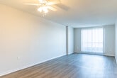 Located at 315 Margaret Avenue in Kitchener, Ontario, this well-appointed one-bedroom, one-bathroom unit offers a functional and comfortable single-floor layout. Light-toned laminate flooring flows consistently throughout, lending a clean and cohesive feel to the entire space.

The entrance leads into a hallway lined with a full-height sliding closet featuring white panels and gold-toned framing, providing generous storage from the moment you step inside. The living room is a bright and open space, anchored by a large sliding window that frames outdoor views and draws in natural light. A ceiling fan adds a practical touch overhead.

The kitchen is efficiently designed with white cabinetry, stone-look countertops, a stainless steel electric range, and a range hood. The layout maximizes usability within a compact footprint. Nearby, in-unit stacked laundry is conveniently tucked into its own dedicated space.

The bedroom is a comfortable size, featuring a sliding-panel closet matching the hallway storage, and a window overlooking the surrounding landscape — offering pleasant natural light and elevated views.

The bathroom is finished with classic white subway tile surrounding a full soaker tub and shower combination, complemented by a bold black-and-white patterned accent wall that adds a stylish contrast. Overall, the unit presents a clean, move-in ready space in a well-located Kitchener neighbourhood.
