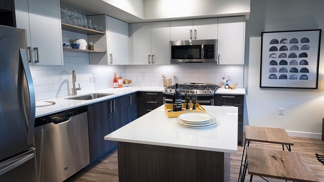 Well appointed kitchens featuring ample storage options - Modera South Lake Union