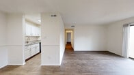 Located in Charlotte, NC, this single-floor, 3-bedroom, 2-bathroom home offers a well-organized layout with a variety of functional spaces. The open living and dining area is a standout, featuring durable wood-style flooring, a classic brick fireplace, and a sliding glass door that leads to a private patio with outdoor views — filling the space with natural light. The galley-style kitchen is efficiently designed with warm-toned wood cabinetry, granite-look countertops, a double-basin sink, and black appliances including a range, dishwasher, and refrigerator. A pantry provides additional storage. The three bedrooms are carpeted and bright, each with natural light from vertical windows. The primary bedroom offers a comfortable, generously sized layout with closet access. Both bathrooms feature wood-tone vanities with white countertops, mirrors with overhead lighting, and clean, neutral finishes — one includes a tiled shower. A dedicated laundry area houses a full-size washer and dryer. Additional spaces include a hallway, multiple closets, and a utility room, providing ample storage throughout. The textured ceilings and neutral white walls create a clean, move-in-ready ambiance throughout the home.