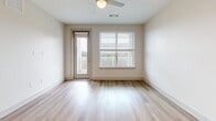 This 700 square foot apartment in Canton, GA offers a well-designed living space with a blend of functionality and modern aesthetics. The single-level floor plan comprises one bedroom, two bathrooms, and an open-concept kitchen and living area. The primary bedroom, measuring 140 square feet, provides a comfortable retreat with plush carpeting and a large window offering natural light and outdoor views.

The kitchen is a standout feature, boasting sleek white cabinetry, stainless steel appliances, and granite countertops. A chevron-patterned backsplash adds a touch of style, while the central island with a sink enhances functionality and provides additional counter space. The living area flows seamlessly from the kitchen, featuring durable wood-look flooring and ample space for both dining and relaxation.

Both bathrooms are well-appointed with granite vanity tops, modern fixtures, and a combination of wood-look flooring and carpet. The apartment also includes a generously sized closet with efficient wire shelving systems, offering abundant storage options.

Large windows throughout the space, some equipped with blinds, allow for plenty of natural light and picturesque views of the surrounding area. The apartment's neutral color palette and contemporary finishes create a bright, airy ambiance that can easily accommodate various decor styles. A private balcony accessible from the living area provides outdoor space for relaxation or entertaining.