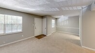 This 2-bedroom, 2-bathroom single-floor home in Savannah, Georgia offers a practical and comfortable layout with a variety of updated finishes. The living area features a distinctive exposed brick accent wall that adds character to the space, complemented by neutral gray walls, plush carpeting, and a textured ceiling. Multiple windows allow natural light to fill the room, and a front entry door provides a welcoming entry point.

The kitchen has been thoughtfully updated with white shaker-style cabinetry, granite countertops, a mosaic tile backsplash, and stainless steel appliances, including a refrigerator, electric range, and built-in microwave. Wood-look flooring ties the kitchen together with a clean, modern feel.

Both bedrooms are carpeted and feature ceiling fans with integrated lighting. The generously sized primary bedroom includes a sliding glass door with vertical blinds leading to an outdoor area. The second bedroom includes a closet with louvered doors and a window overlooking the outdoors. A dedicated closet space provides additional storage and houses the water heater.

The two bathrooms are clean and functional, each featuring a tub-shower combo with white tile surrounds. One bathroom includes a granite-topped vanity with white cabinetry and wood-look flooring, while the second is finished with classic white tile. The overall layout is efficient, connected by a central hallway.