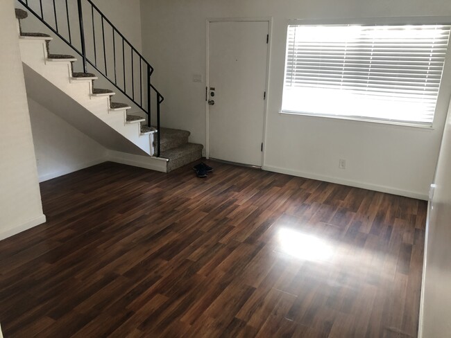 Looking from eating area . Living room, front door, stairs to 2nd story - 63 S 9th St