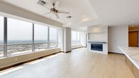 Located in the heart of Dallas on Federal Street, this sophisticated 3-bedroom, 6-bathroom residence offers an elevated urban living experience with panoramic city skyline views. The open-plan living area is anchored by a sleek fireplace and expansive floor-to-ceiling windows that flood the space with natural light, while light-toned hardwood flooring and tray ceilings add architectural refinement throughout.

The chef's kitchen is a standout feature, showcasing a grand waterfall-edge stone island, warm wood cabinetry, stainless steel appliances including a built-in refrigerator, and a statement range hood — all designed for both functionality and style.

The generously sized primary bedroom captures sweeping skyline views through oversized windows and is complemented by a walk-in closet and a luxurious en-suite bathroom. The bathroom features large-format white tile flooring, a glass-enclosed shower with travertine-style tile walls and hexagonal mosaic tile flooring, and a well-appointed vanity. Additional bedrooms are equally spacious, each with access to well-designed closets and bathrooms. A dedicated laundry room and recessed lighting throughout complete this refined urban residence.