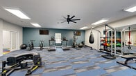 Located in Decatur, Georgia, this single-floor fitness facility offers a comprehensive exercise environment designed to support a wide range of workout routines. The main exercise area features blue and gray patterned carpet tiles underfoot and is illuminated by recessed panel lighting and large ceiling fans that promote airflow throughout the space. The room is anchored by a teal accent wall that adds a vibrant, energetic atmosphere.

The cardio zone is well-appointed with multiple treadmills, an elliptical, and stationary spin bikes, while flat-screen televisions mounted on the walls provide entertainment during workouts. The strength and functional training section includes a cable machine, a heavy punching bag, a weight rack stocked with medicine balls and free weights, and a tire sled for high-intensity training. Full-length mirrors further enhance the strength area, allowing users to monitor their form.

An open floor area provides ample room for functional and group exercises, with French doors offering natural light and outdoor access. A separate multipurpose room, distinguished by its colorful checkerboard-patterned floor tiles, features a round table with seating — ideal for small group meetings or stretching sessions. Ceiling fans and overhead lighting carry through this space as well, maintaining a comfortable and consistent environment throughout the facility.