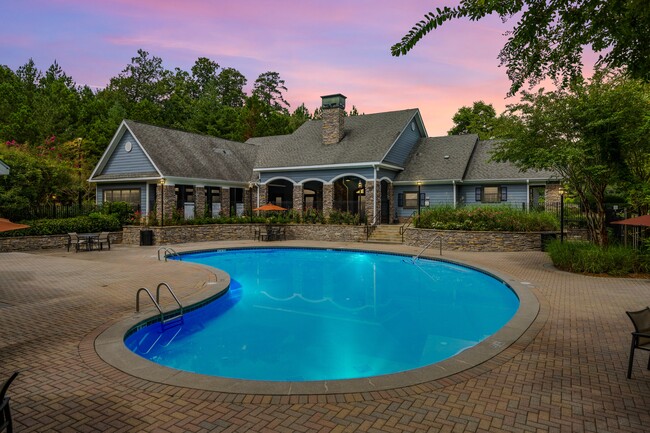 Swimming pool and clubhouse at sunset - Heritage at Riverstone