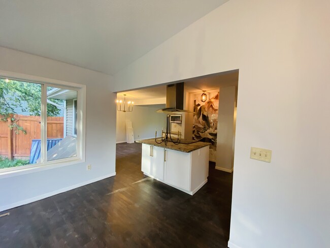 Family room flowing into an open kitchen and Formal Living Room in the back. - 4219 Boone Ave N