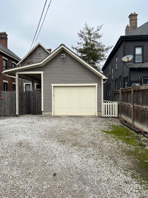 Entrance to extra large garage with attic storage . Another parking spot is left of garage - 215 Thurman Ave