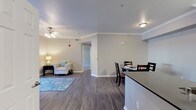 Located at 1168–1178 Corporate Way in Sacramento, California, this single-floor residence offers a thoughtfully designed layout with modern finishes throughout. The open-concept living and dining area serves as the heart of the home, featuring wood-style flooring, crown molding, and a ceiling fan that enhances both comfort and style. A sliding glass door in the living room floods the space with natural light and provides direct access to a private outdoor balcony. The dining area offers a defined space ideal for everyday meals or entertaining guests. The kitchen is outfitted with white cabinetry, dark granite-style countertops, a stainless steel dishwasher, and a deep undermount sink — combining functionality with a clean, contemporary aesthetic. Bedrooms are carpeted for comfort and include generous closet space, with one bedroom featuring a walk-in closet. Natural light filters in through windows with blinds in each bedroom, creating a bright and welcoming atmosphere. The bathroom is well-appointed with a wide vanity, dark countertop, white cabinetry, a large mirror, and a full soaking tub with shower. Neutral tones and consistent finishes throughout the home contribute to a cohesive and inviting overall ambiance.