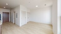 Studio #304 is a thoughtfully designed 340-square-foot studio apartment located at 106 S Buchanan St in Spring Lake, Michigan. The single-floor unit features an open layout with light hardwood flooring and crisp white walls throughout, creating a bright and airy atmosphere. Recessed lighting illuminates the main living area, which also benefits from a large window allowing natural light to flow in and offering views of the surrounding area.

The modern kitchen is well-appointed with warm wood cabinetry, open shelving, white quartz countertops, and a classic white subway tile backsplash. Stainless steel appliances — including a refrigerator, electric range, microwave, and dishwasher — provide full functionality. A stainless steel sink with a contemporary faucet completes the space.

The living area includes a closet with louvered doors alongside an additional storage closet, offering practical organization options for a studio setting. The full bathroom features a combination tub and shower, a toilet, and a vanity with an undermount sink, wood cabinetry, and a large wall mirror, all finished in a clean, neutral palette. A wall-mounted light fixture adds bright, functional illumination. This studio offers a compact yet efficient layout suitable for modern single-occupant living in Spring Lake.