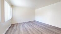 Located at 5220 Harmony Ave in North Hollywood, Los Angeles, this single-story, one-bedroom, one-bathroom unit offers a clean and functional layout designed for comfortable everyday living. Light wood-style flooring runs consistently throughout the space, creating a cohesive and airy feel.

The open-concept area seamlessly combines the living room, dining room, and kitchen into one connected space. The kitchen is well-appointed with white shaker cabinetry, granite-style countertops, a stainless steel gas range with overhead ventilation, and a built-in sink. A skylight above the kitchen adds an extra touch of natural brightness to the space.

The bedroom is a comfortable size and features a window with vertical blinds that allows natural light in while offering views of the surrounding greenery. A dedicated closet provides convenient storage directly off the bedroom.

The bathroom is spacious and features light wood-style flooring, a white vanity with granite-style countertop, a full bathtub with accessibility grab bars, and clean white walls that contribute to a bright, open feel.

A hallway connects the main living areas to the private spaces, keeping the layout organized and easy to navigate. Neutral cream-toned walls and consistent flooring throughout give the unit a cohesive, move-in-ready appearance.