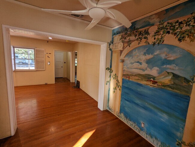 Dining room with mural of italian country site and living room - 336 N Fairview St